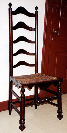 Slat-back chair with five slats, boldly turned legs and stretcher, and cyma-curved skirt