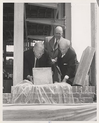 black and white photo of 3 men laying cornerstone