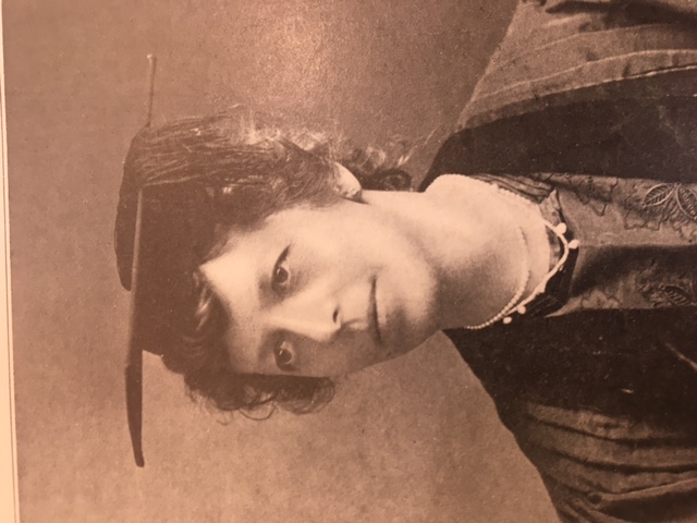 photo of woman in sepia tone wearing college graduation wear