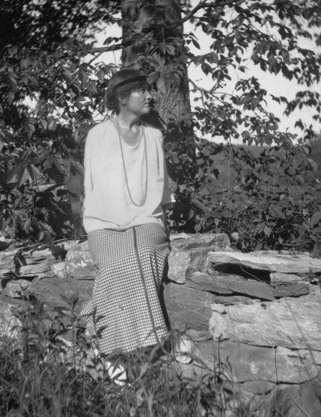 black and white photo of Elsie Clews Parson standing amid trees