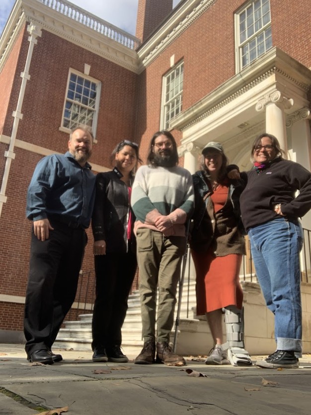 photo of 5 people standing in front of steps of Library Hall