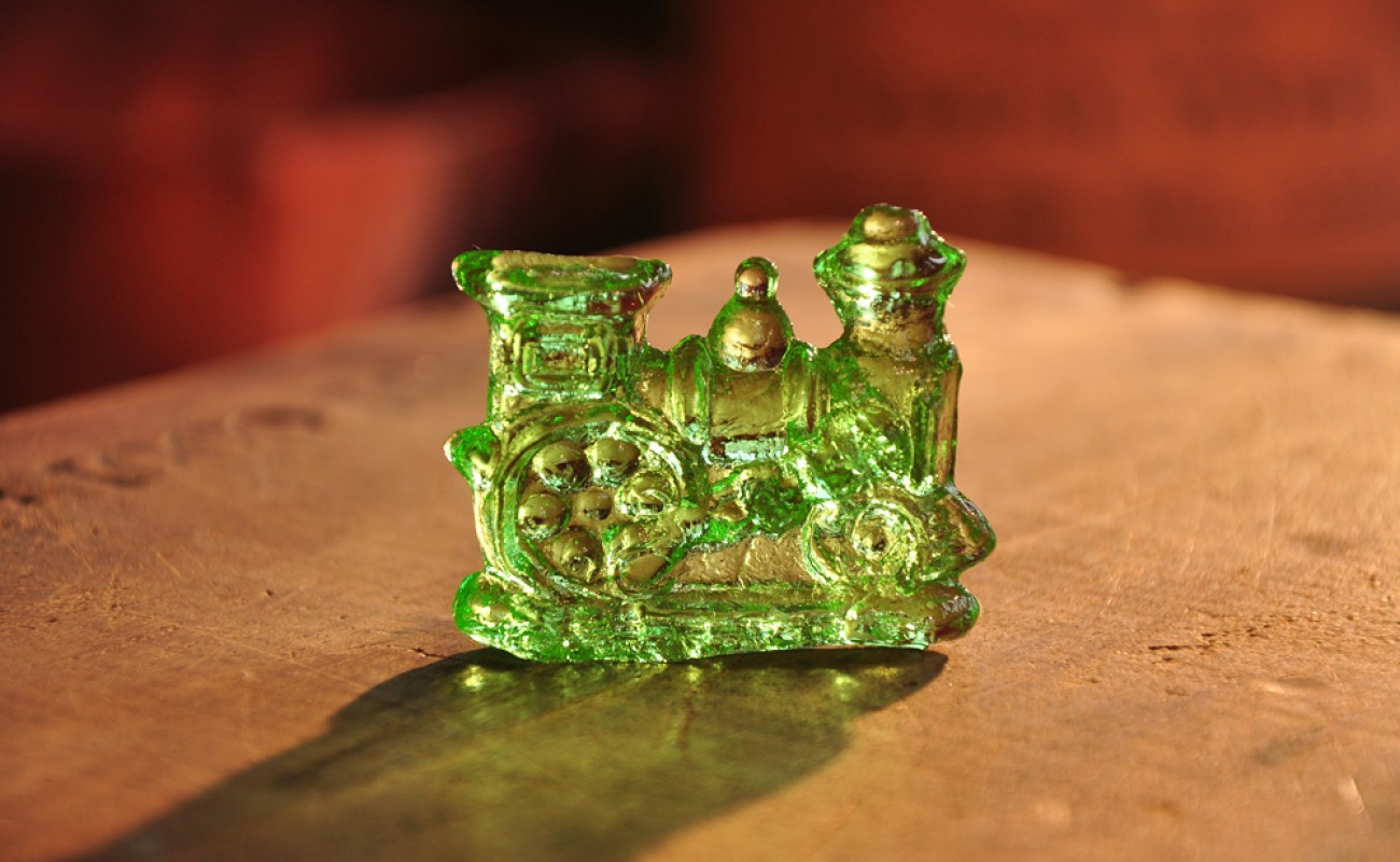 green train made of clear toy on a table