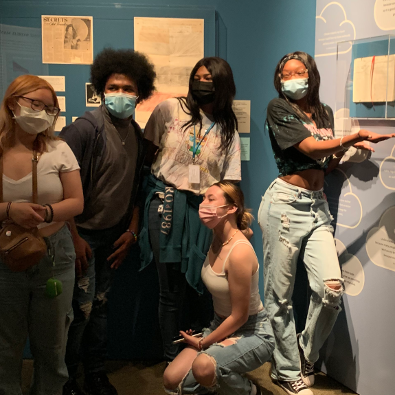 five masked students standing in Museum gallery